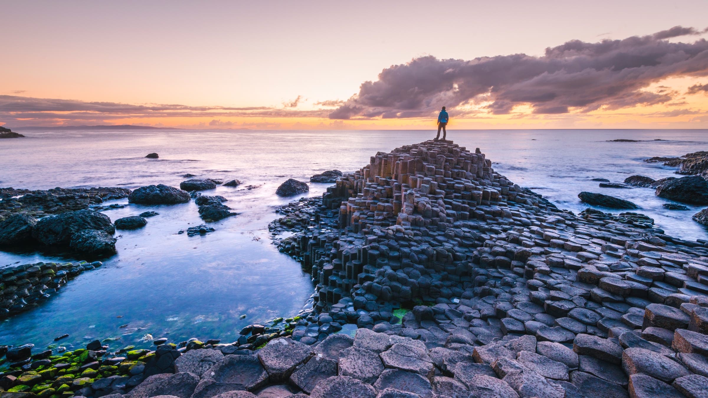 Man standing on rock on sea