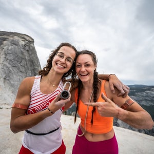 two women standing on top of half dome after completing the yosemite triple crown