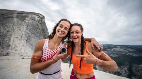 two women standing on top of half dome after completing the yosemite triple crown