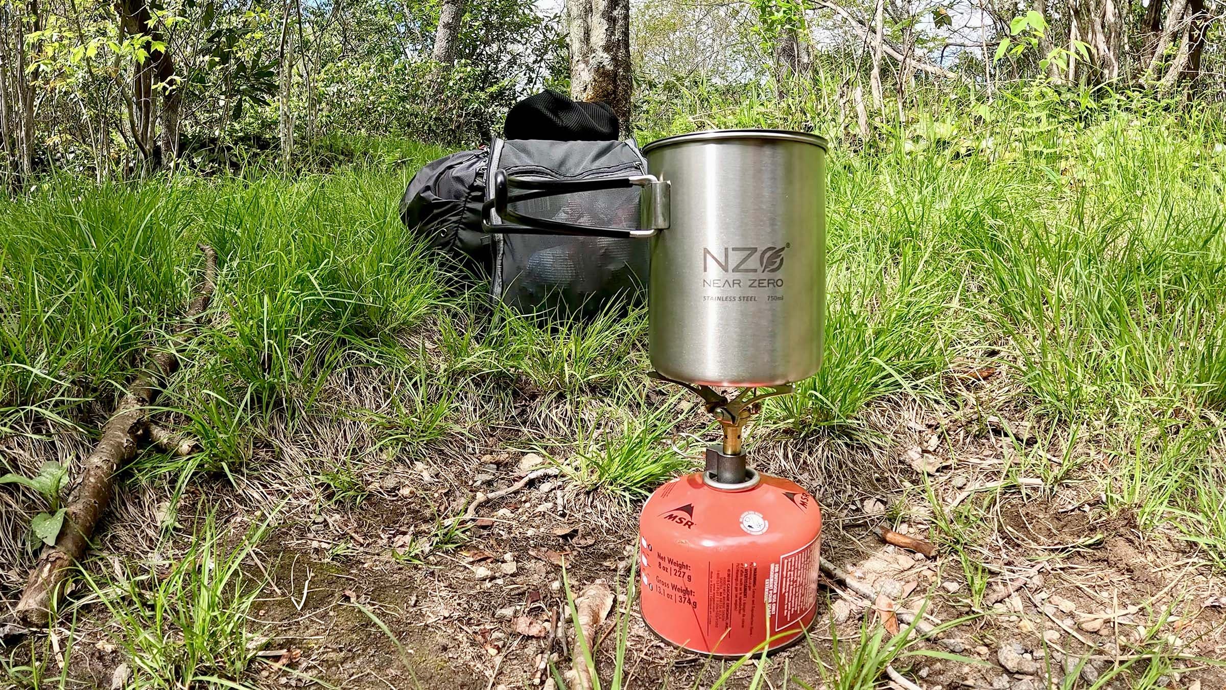 Closeup of backpacking stove set up in grassy area