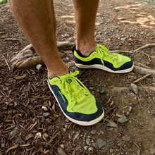 Neon green shoes on rocky ground