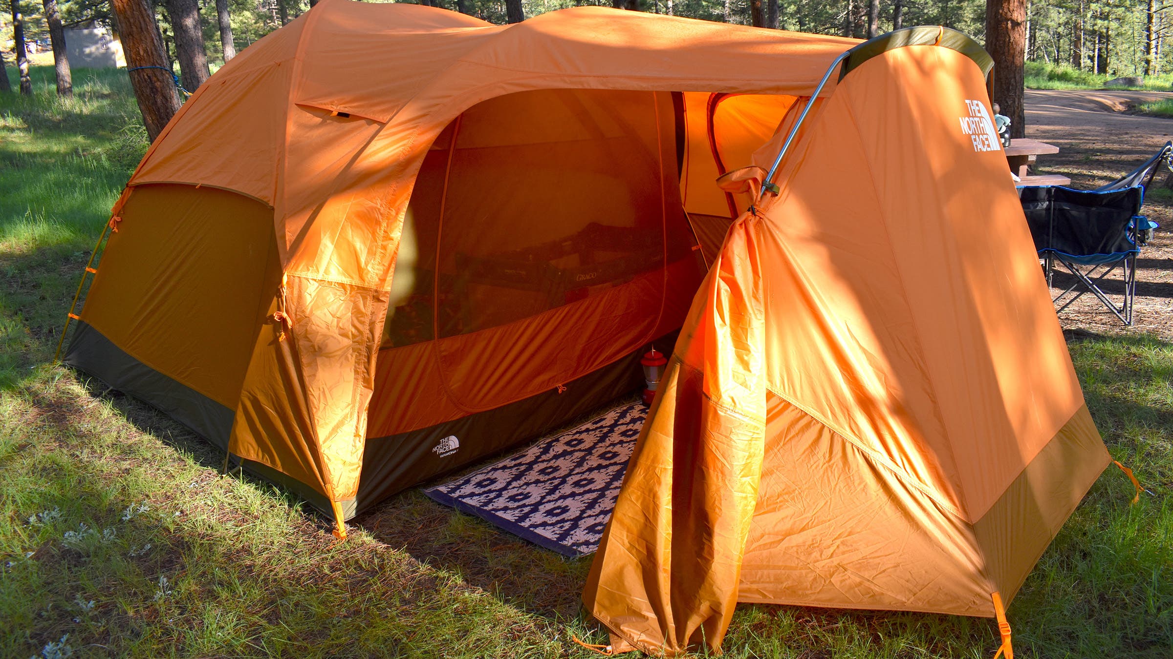 Orange North Face Wawona 6-person tent pitched in woods