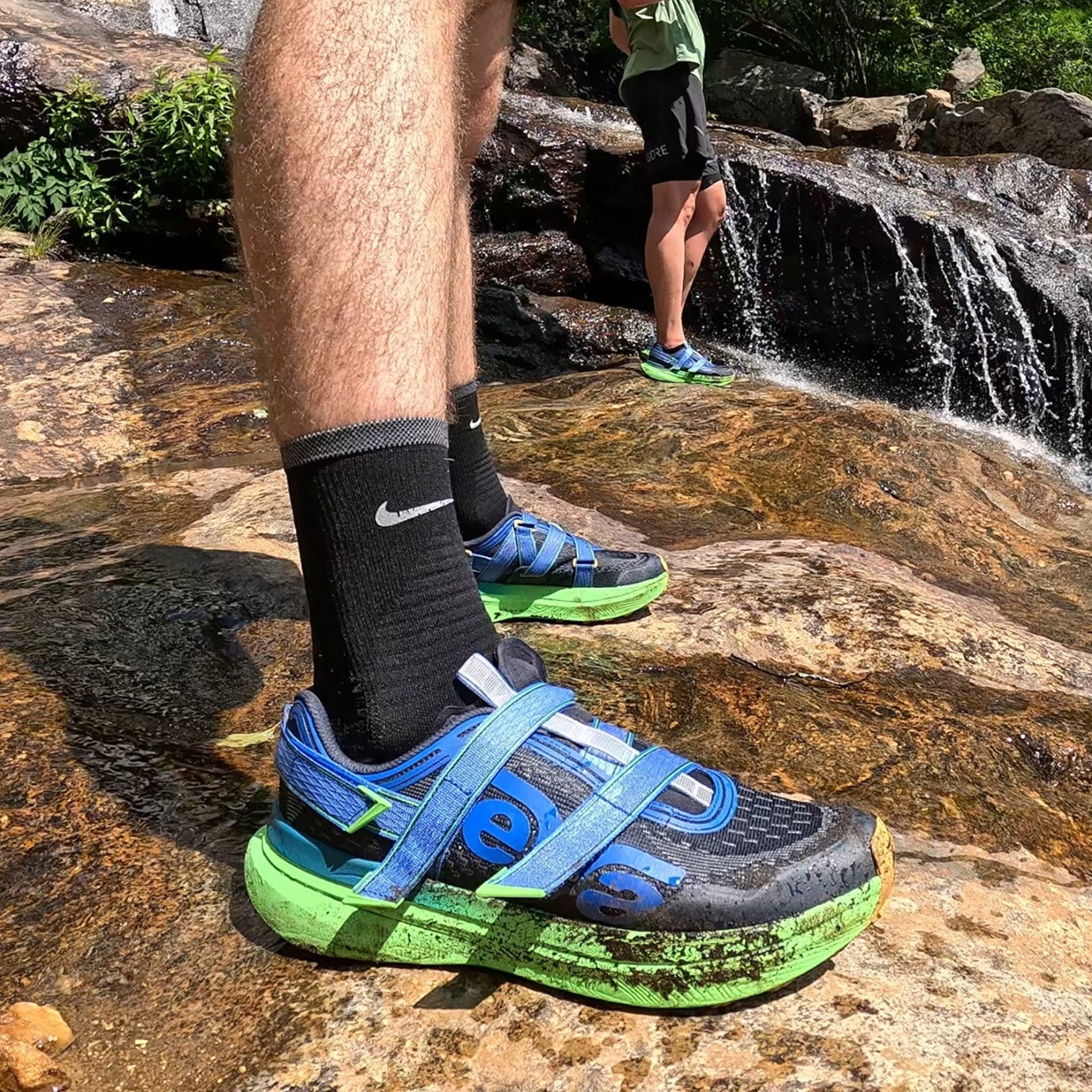 Closeup of blue Teva Aventrail sneakers on waterfall hike