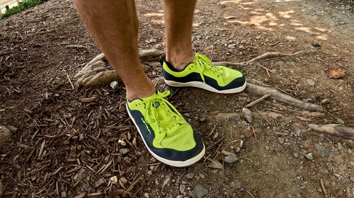 Neon green shoes on rocky ground