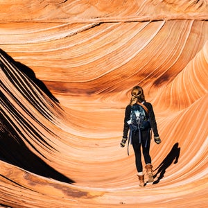 woman hiking The Wave red rocks