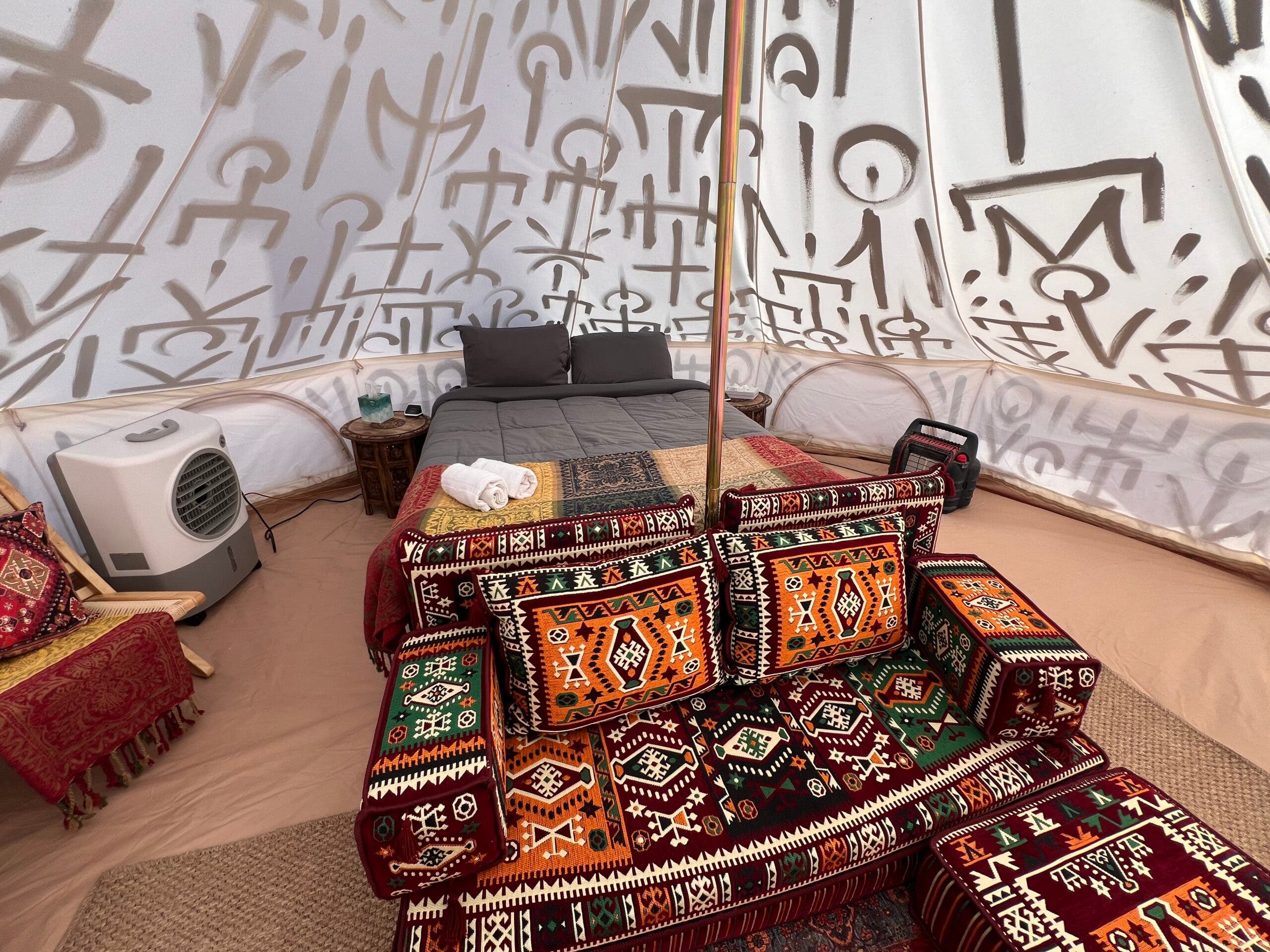 inside a tent with a sofa and bed
