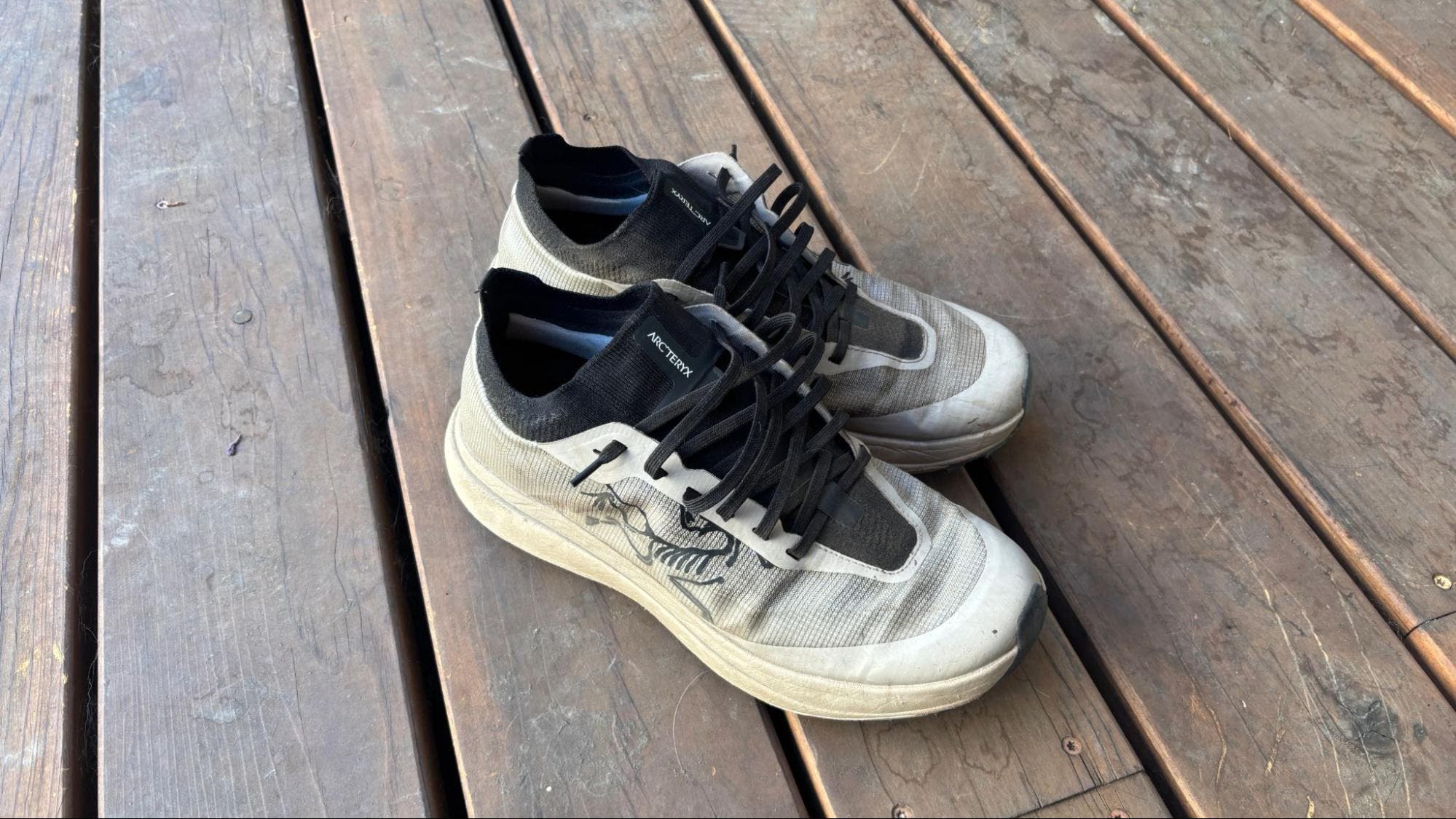 Arc'teryx Sylan Pro trail running shoes on wooden deck