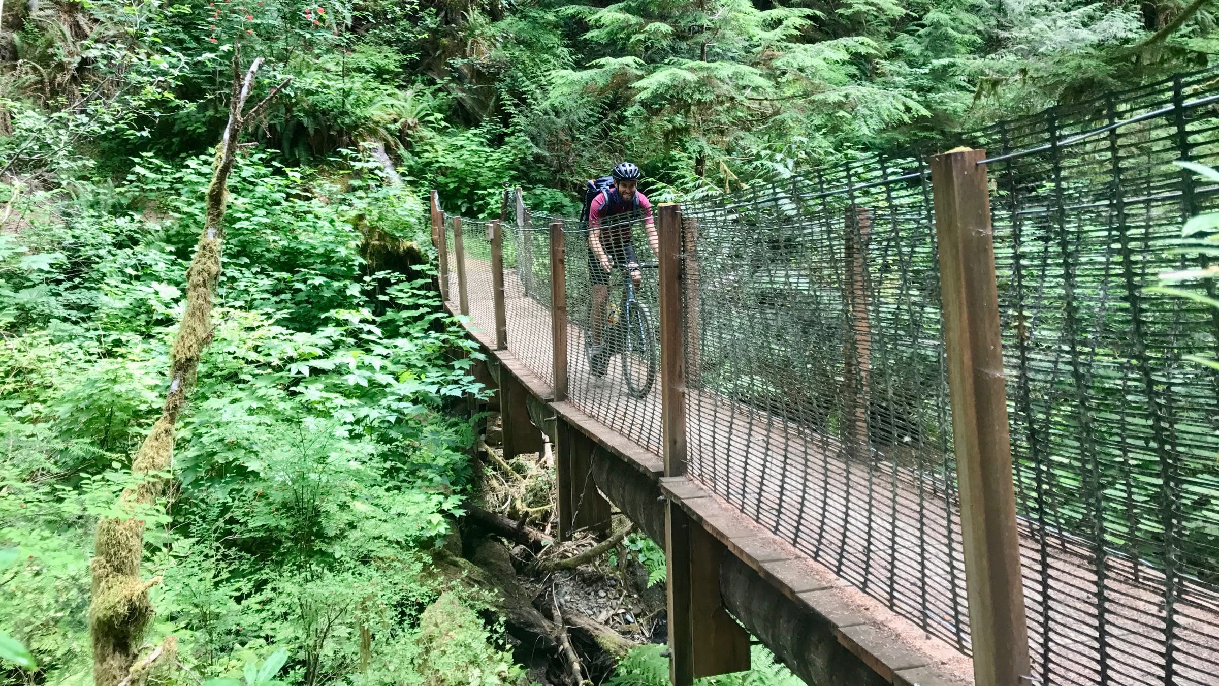 Biker going across bridge
