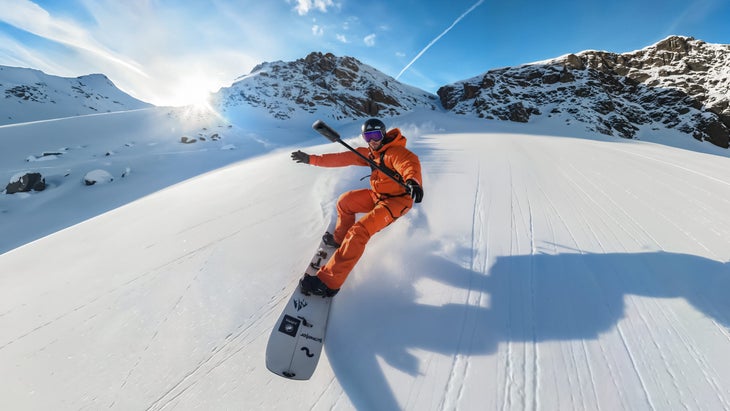 A snowboarder shreds while using the X5 with the handheld Selfie Stick.