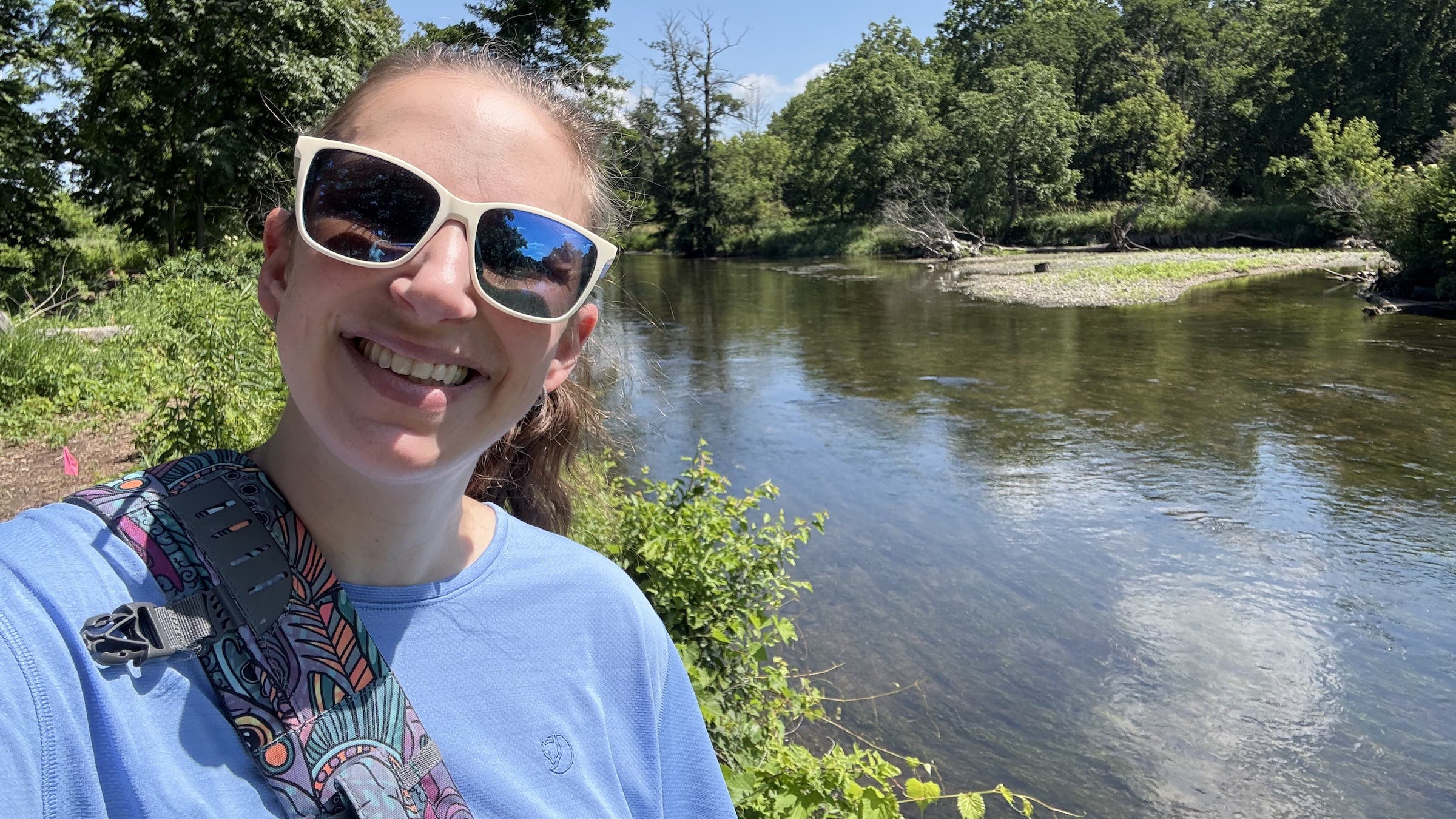 a woman taking a selfie by the river