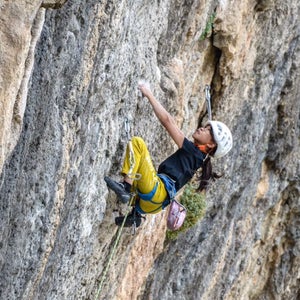 little girl climbing big wall