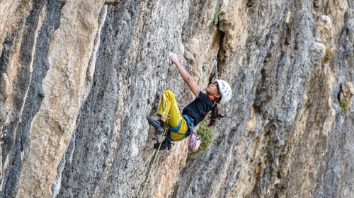 little girl climbing big wall