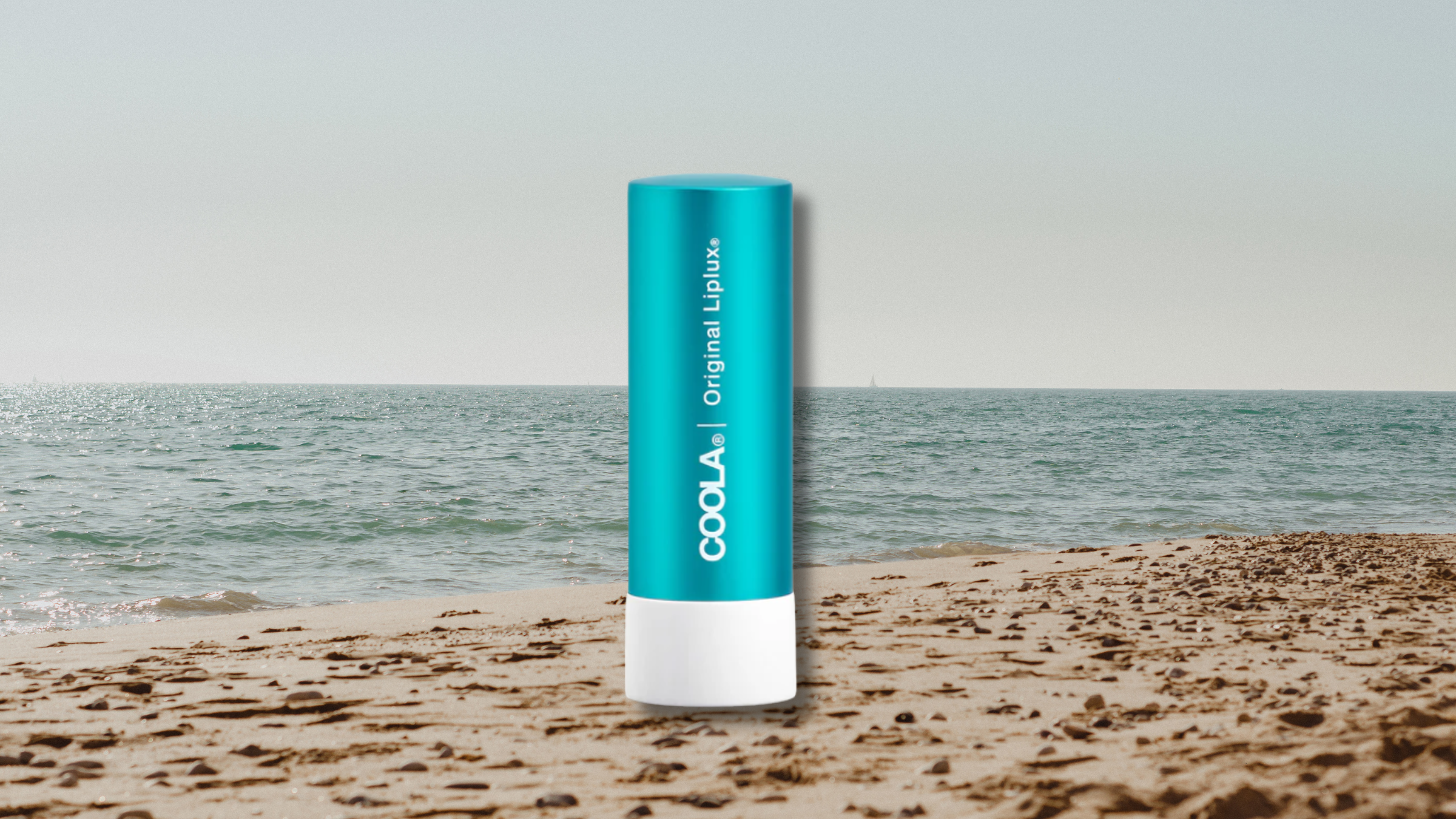 coola spf lip balm on beach