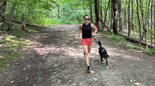 woman and dog on trail with leash for dog running