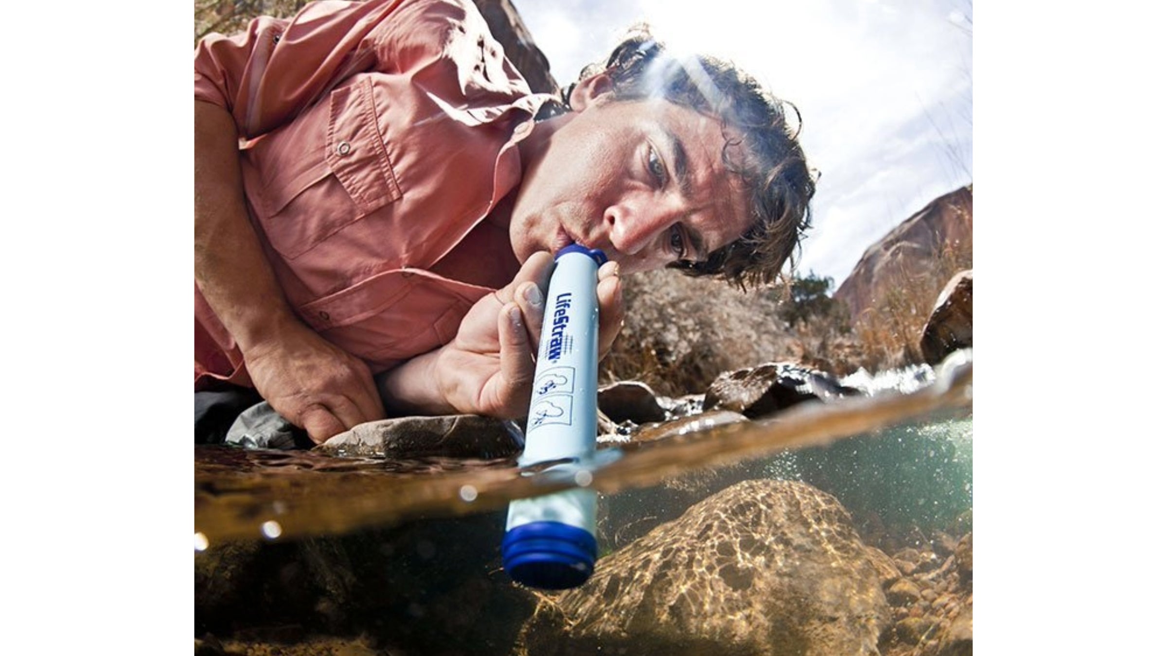 man drinking from lifestraw