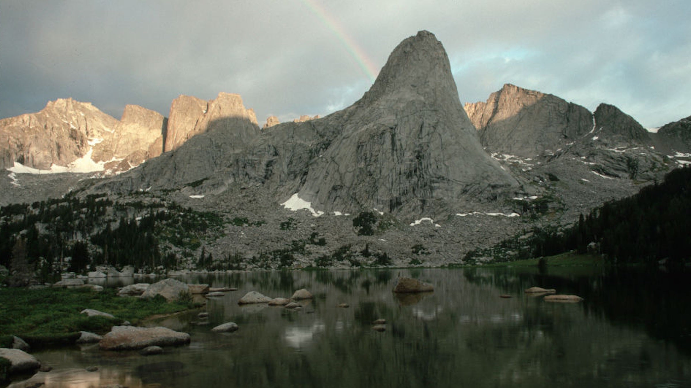 mountains and rainbow over lake