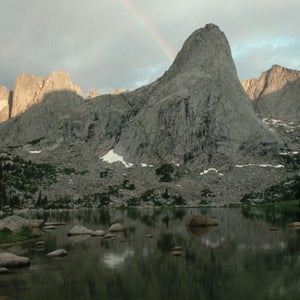 mountains and rainbow over lake