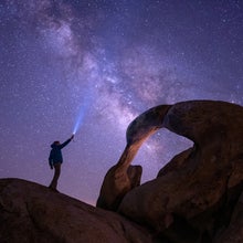 Low angle view of man standing on rock against sky at night, Alabama Hills