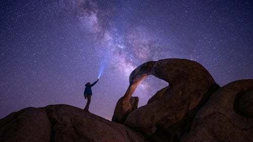 Low angle view of man standing on rock against sky at night, Alabama Hills