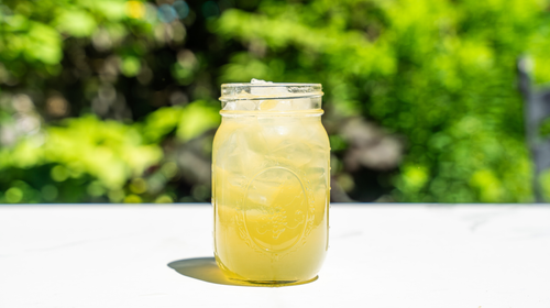 a mason jar filled with pickle lemonade