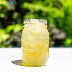 a mason jar filled with pickle lemonade