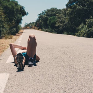 woman lying down on road