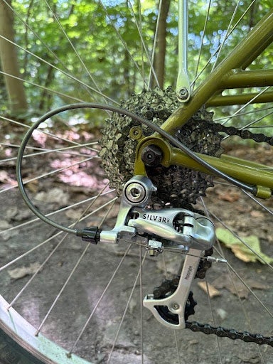When downshifting with the OM-1, the chain flew right up the cassette with the flick of the lever, and because of the low-normal action, front and rear shifting actions now matched. With the Silver shifters in under-the-bar-thumbie mode, that meant forward to downshift, and back to upshift, on both the front and the rear.