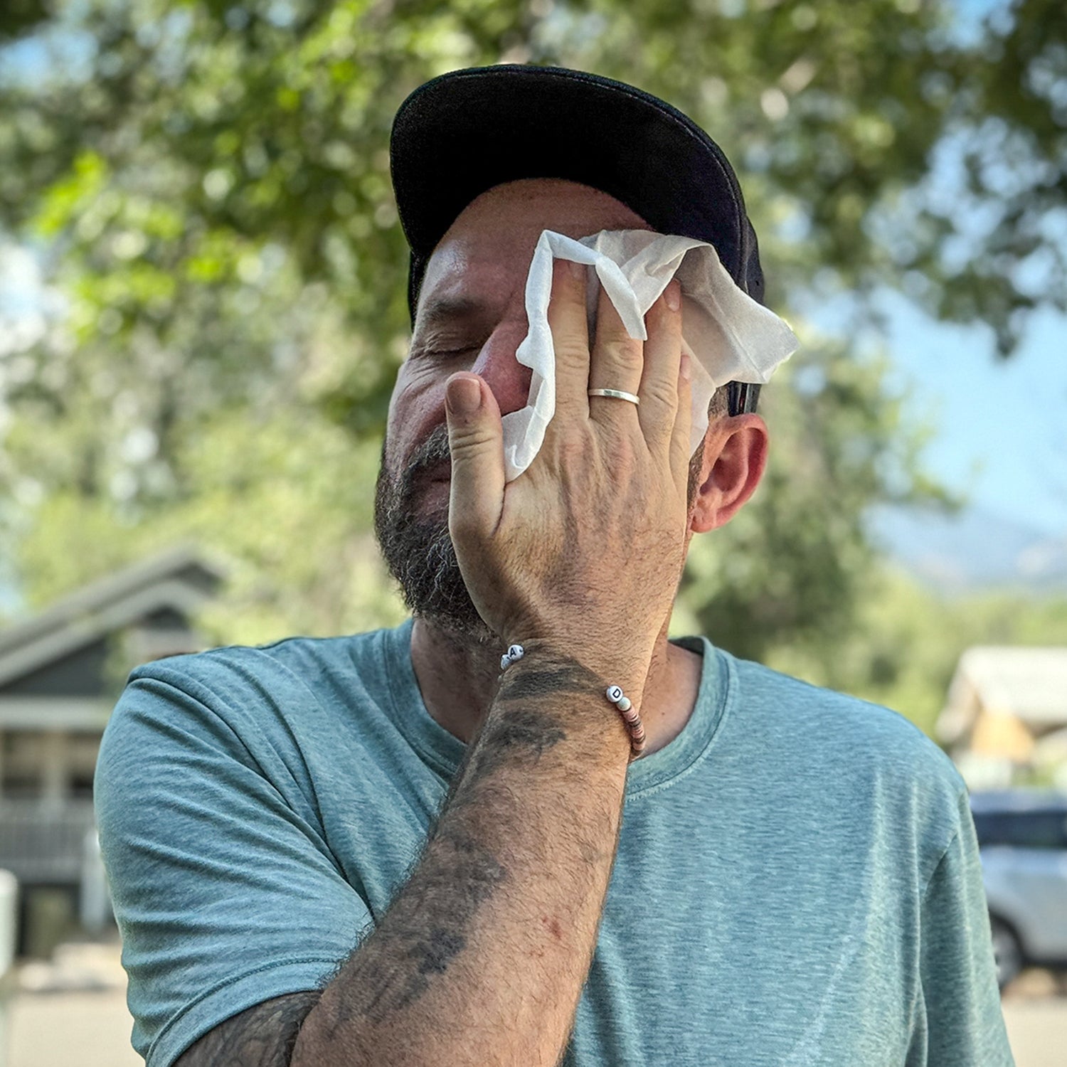 Runner using wet wipe to clean face