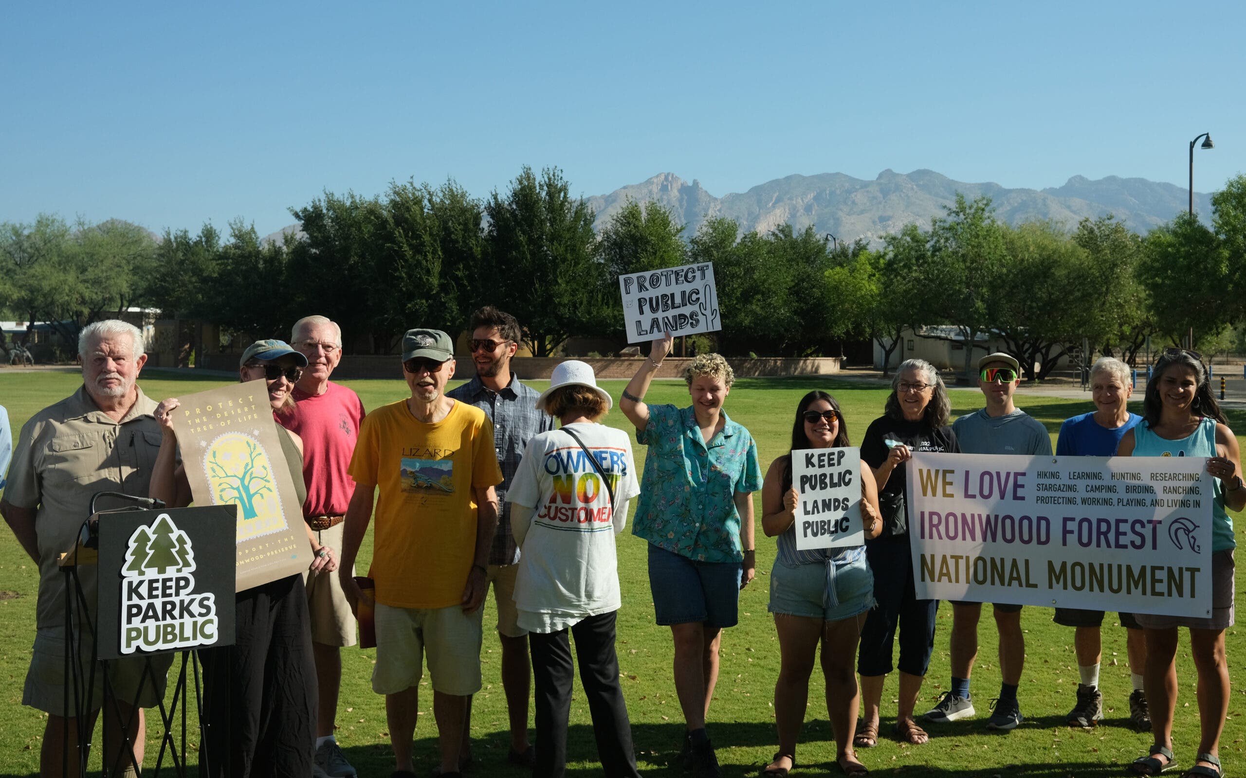 Public land advocates hold protest signs