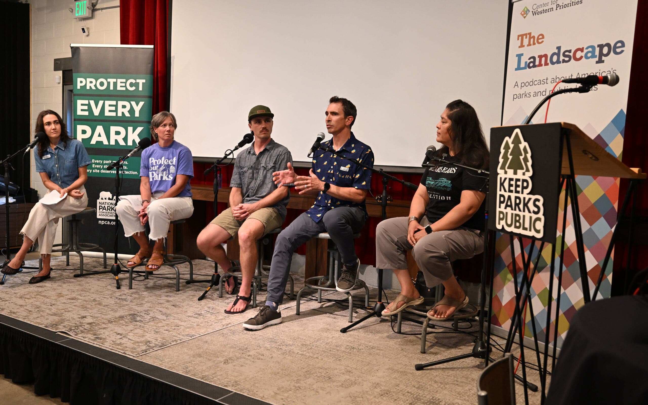 Speakers from the Center for Western Priorities speak in front of a crowd