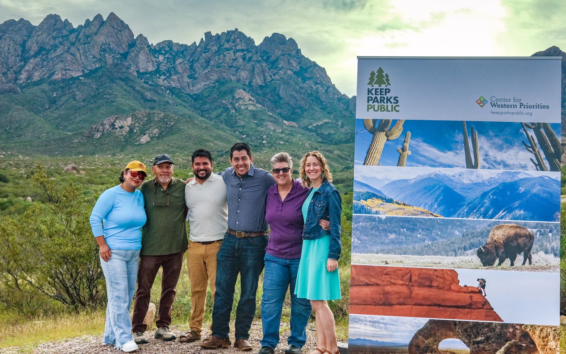 Advocates stand in front of a mountain range outside Las Cruces, New Mexico