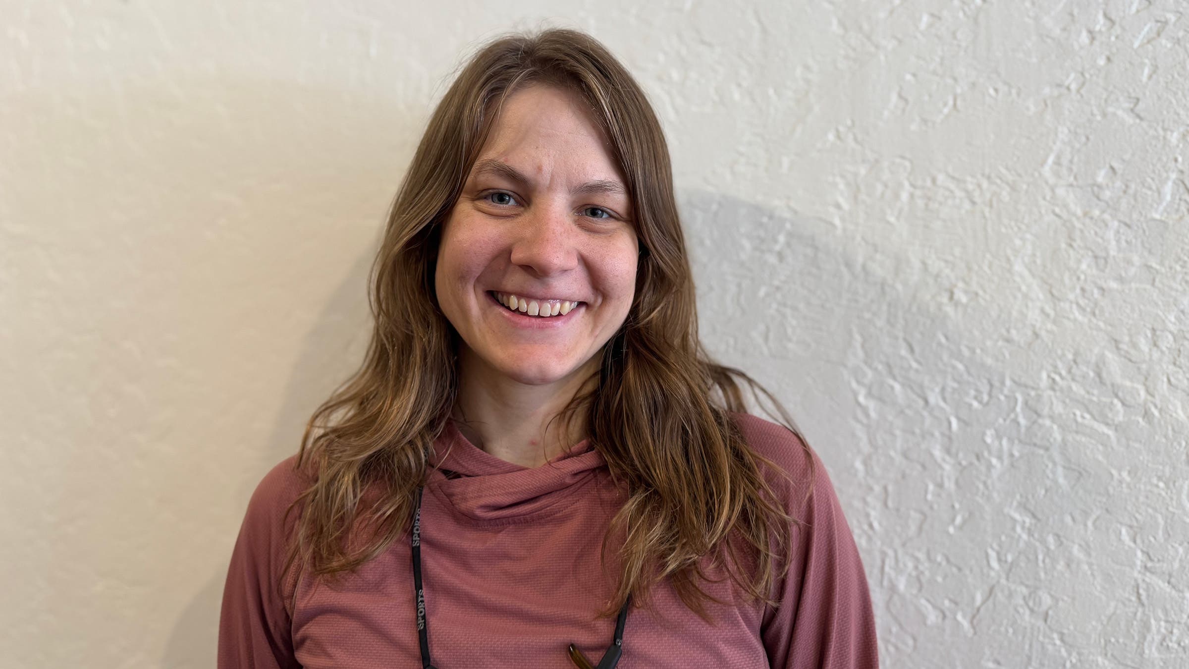 Closeup of woman PCT Hiker posing in front of white wall
