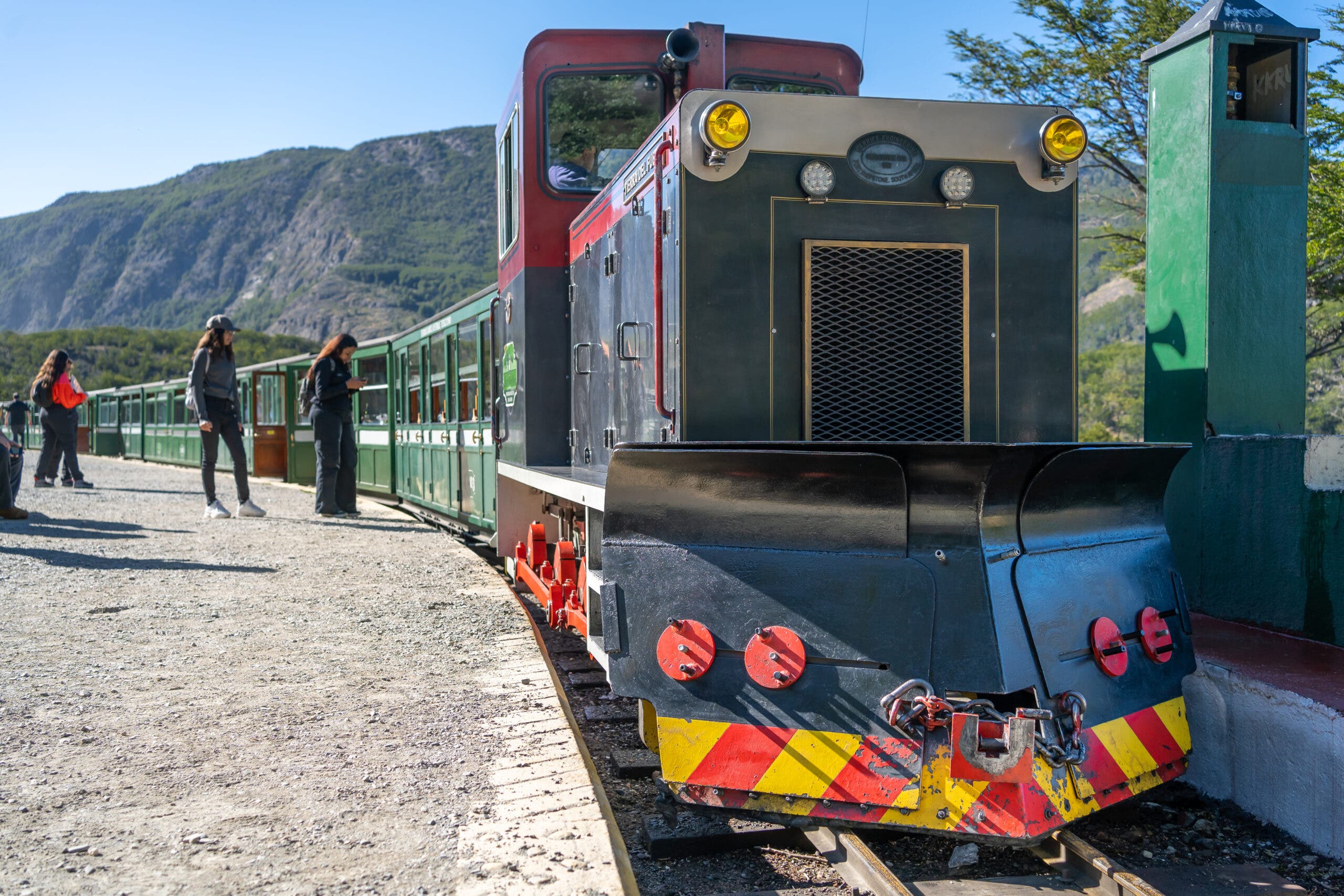 Passengers get off the End of the World Train at a station in Ushuaia National Park.