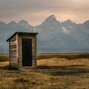 Outhouse in front of the Grand Tetons.