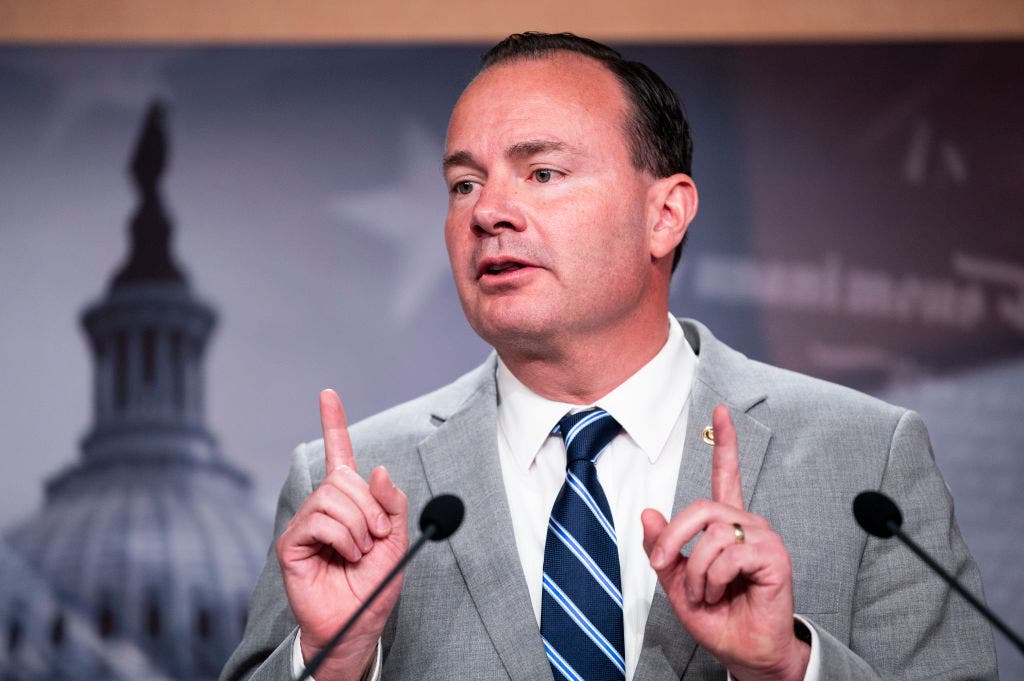Utah senator Mike Lee points upwards
