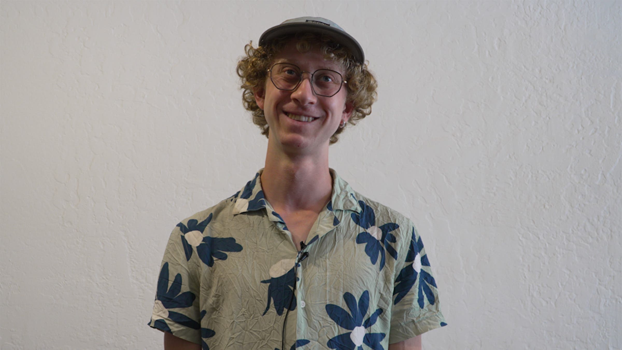 Male PCT Hiker posing in front of while wall