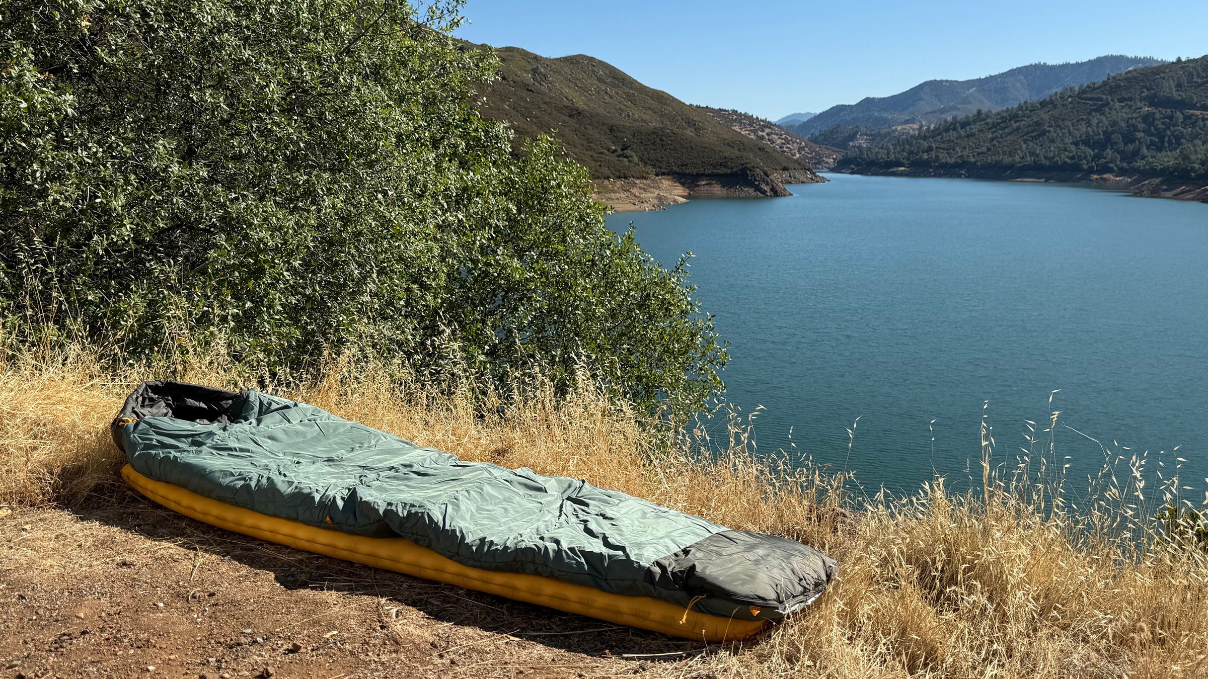 Sea to Summit sleeping pad covered with sleeping bag at the edge of a lake