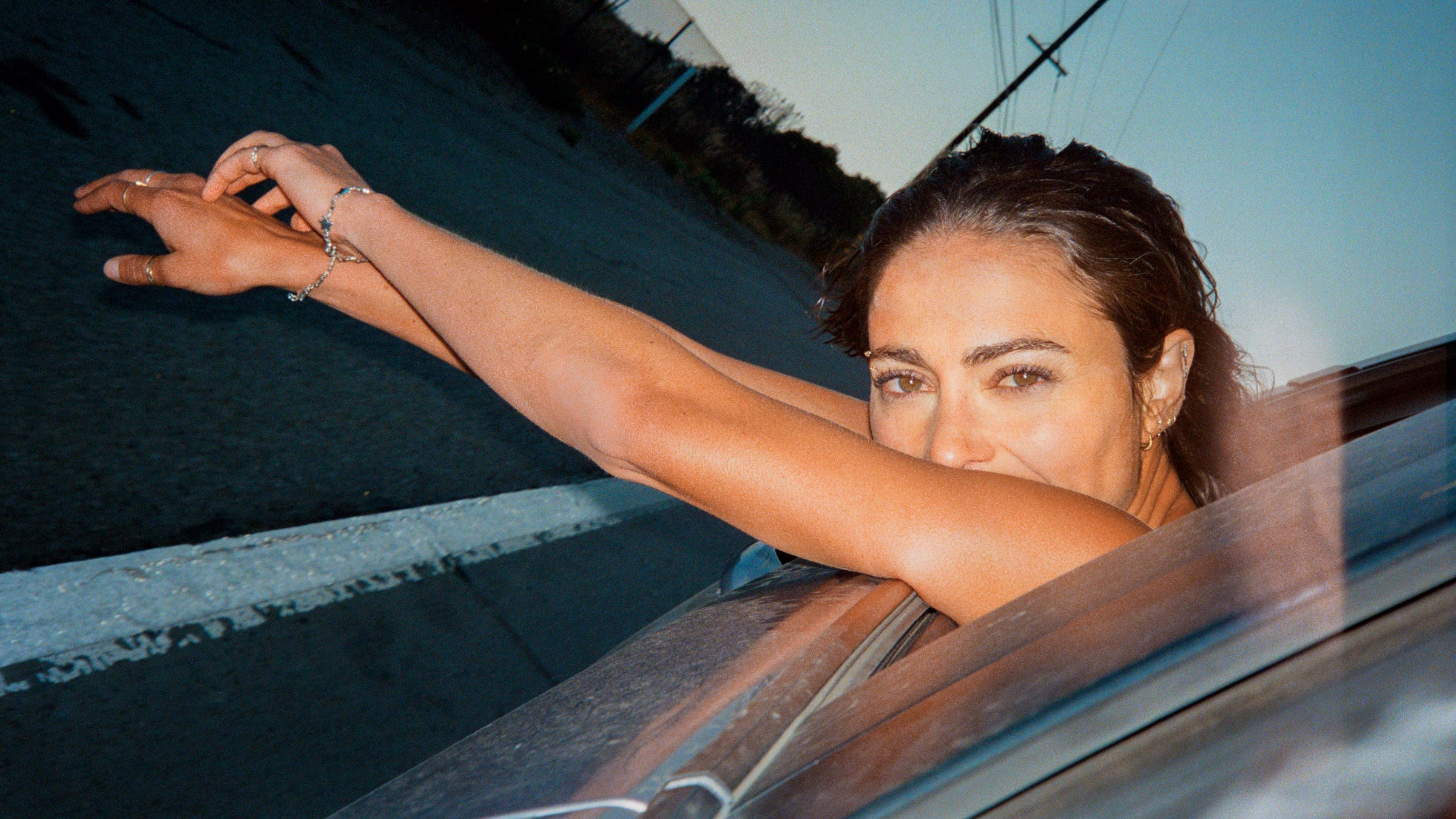 Alexi Pappas leaning out a car window