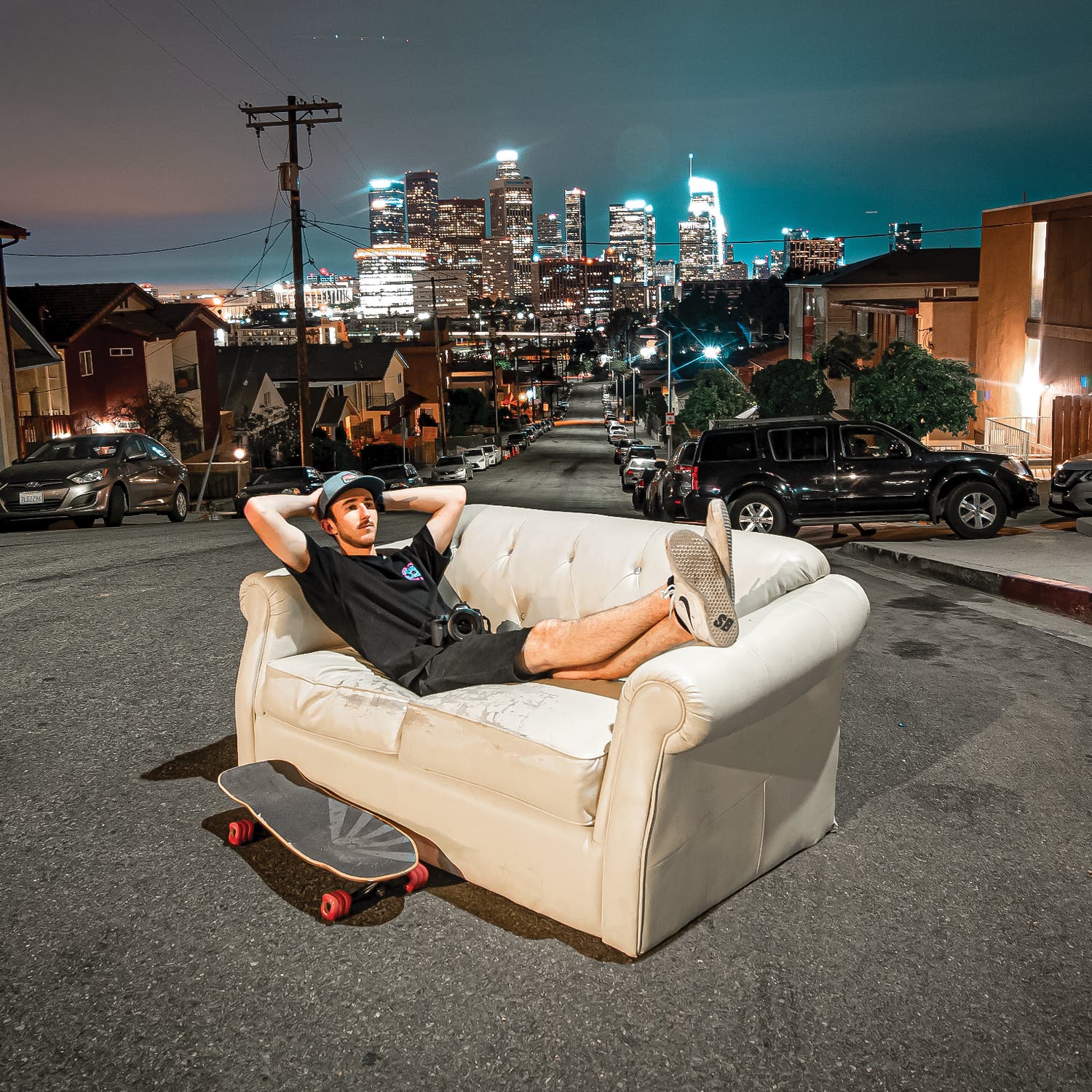 Tyler Paget on a couch in a city