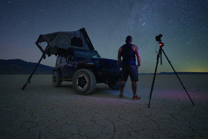Photographer Jay Clue stands in the desert waiting for magic to happen. 