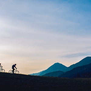 two cyclists biking easily in mountains
