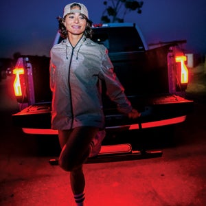 Alexi Pappas stretching in front of a truck