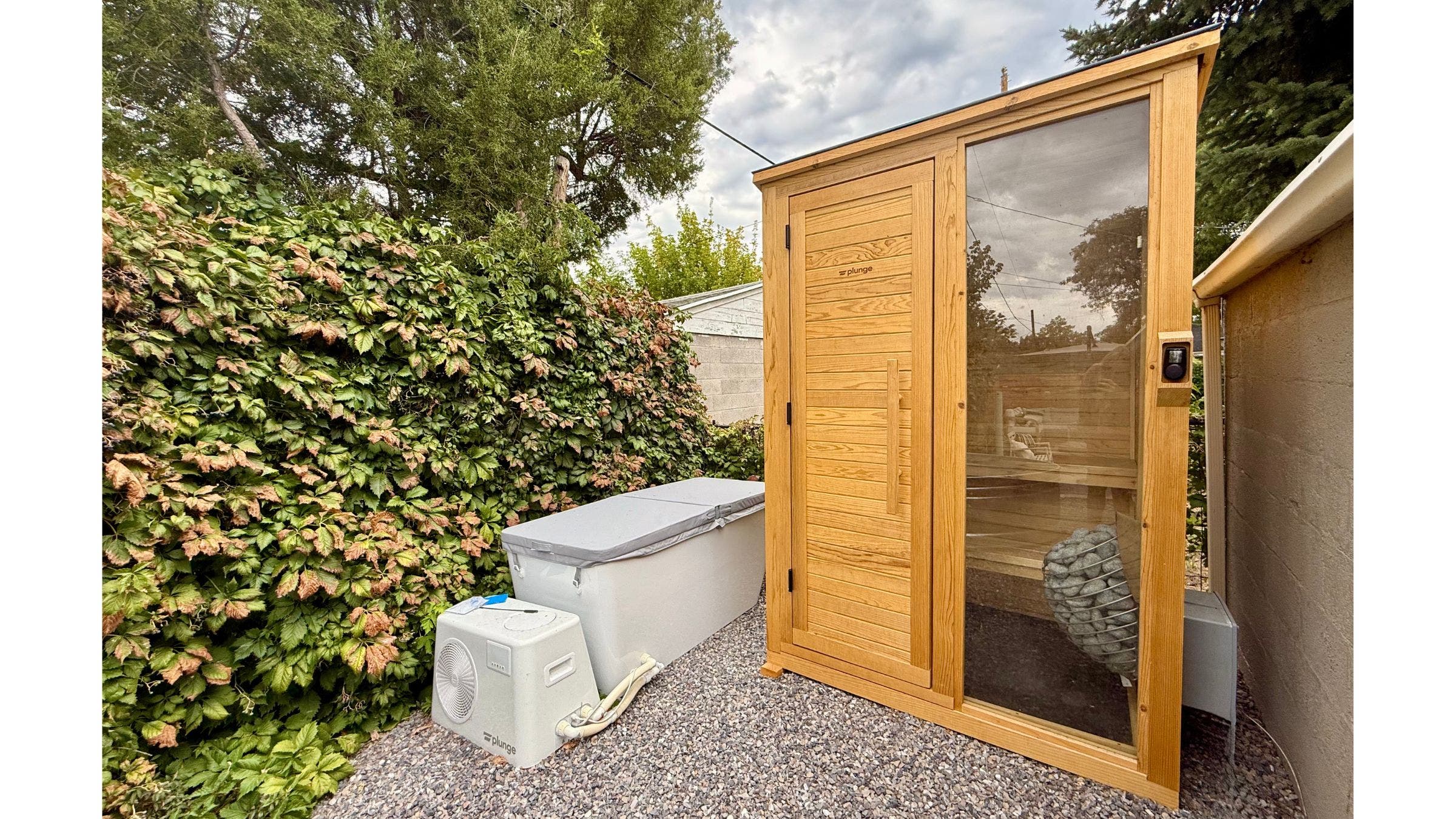 wooden sauna in backyard over rocks