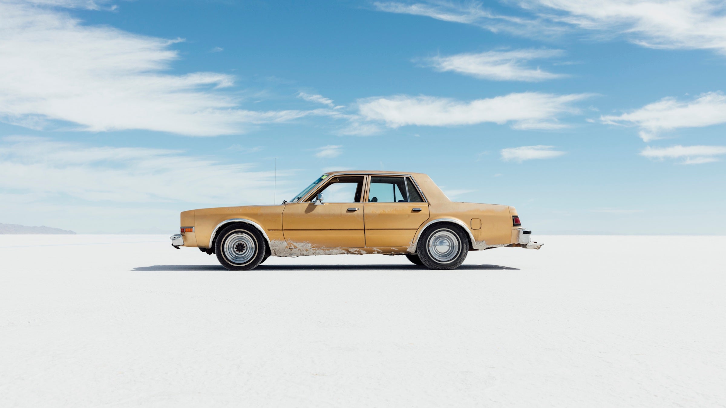 sedan adventure vehicle parked on salt flats
