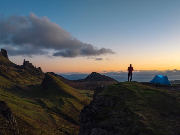 man standing in front of tent