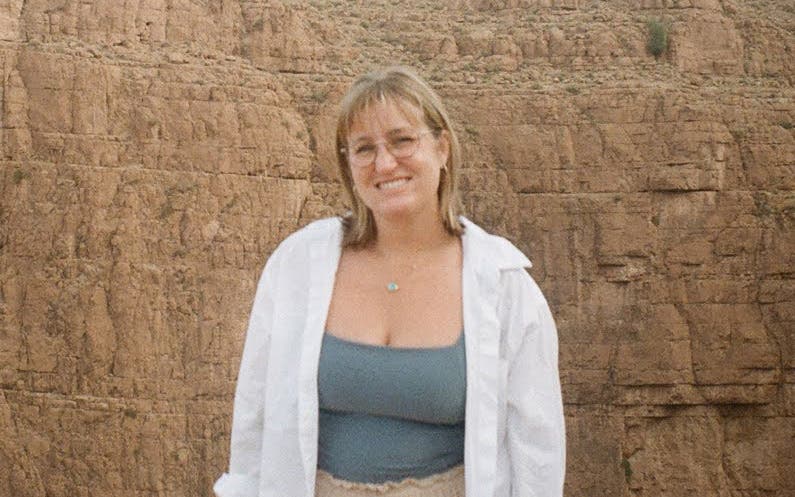 author Madison Chapman standing in front of a cliff