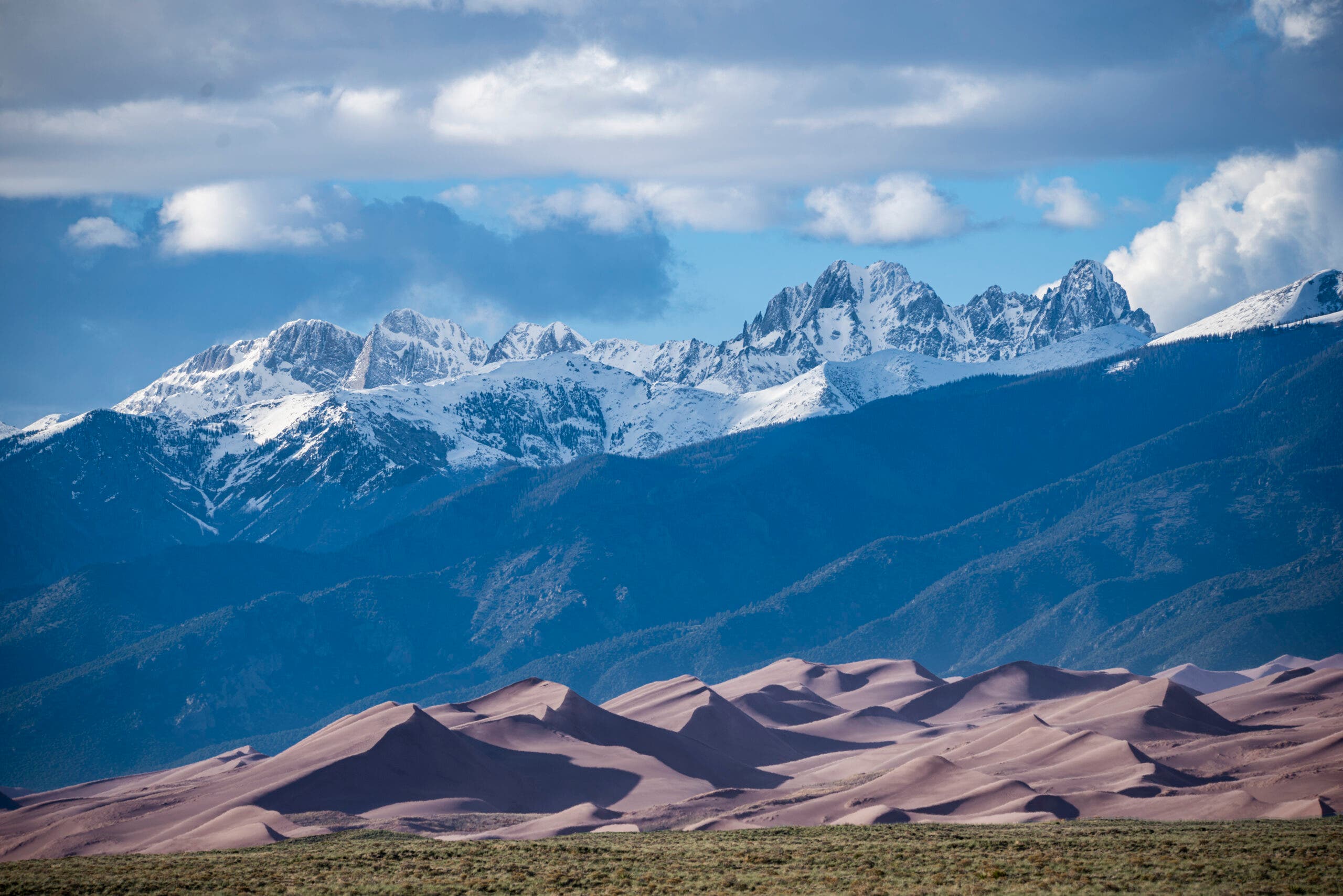 Telescopic view of the Sangre de Cristo mountain range over Great Sand Dunes National Park.