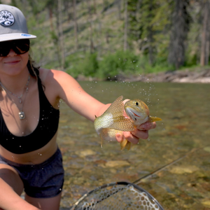 square crop of woman holding golden fish