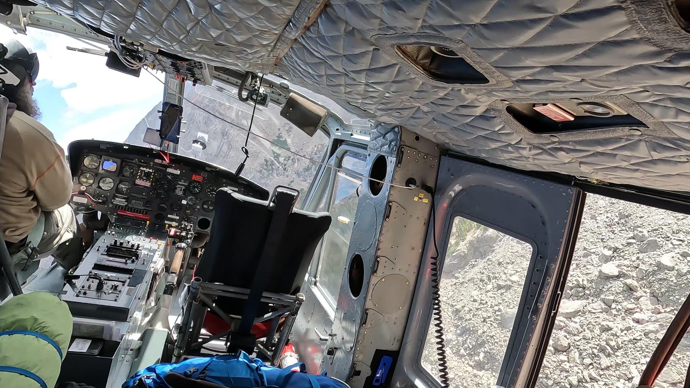 Oates banks the helicopter over the Angelica Couloir boulder field on Mount of the Holy Cross