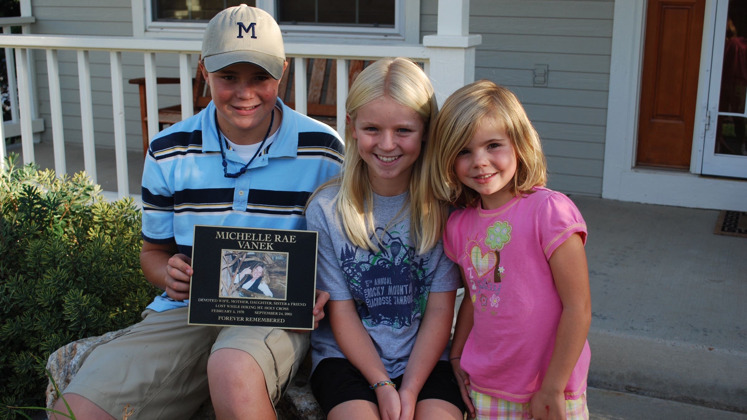 Grant, Ali, and Haley Vanek in Lakewood with a memorial plaque the family installed on Mount of the Holy Cross in 2009